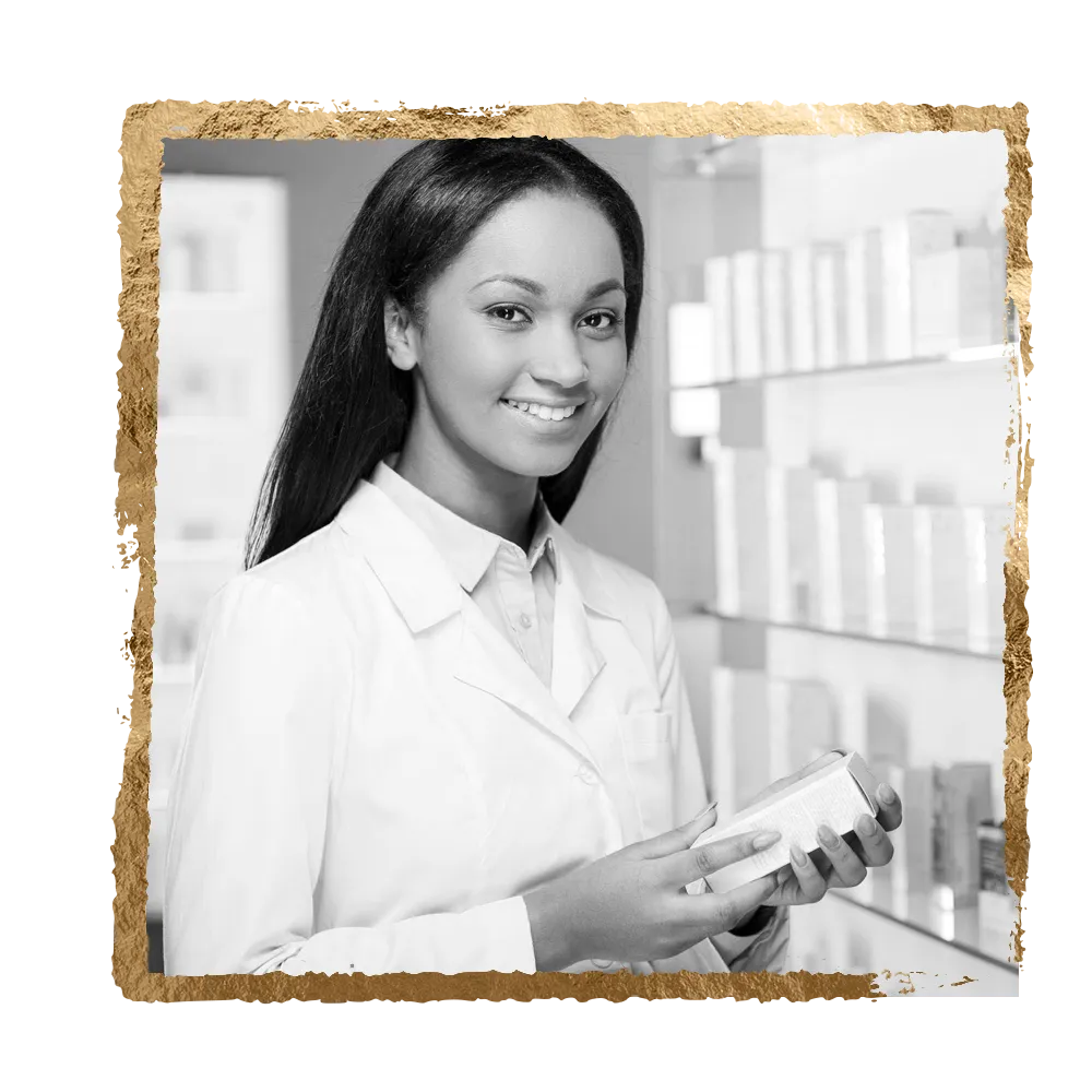 Pharmacist holding a box in a pharmacy, smiling, white lab coat